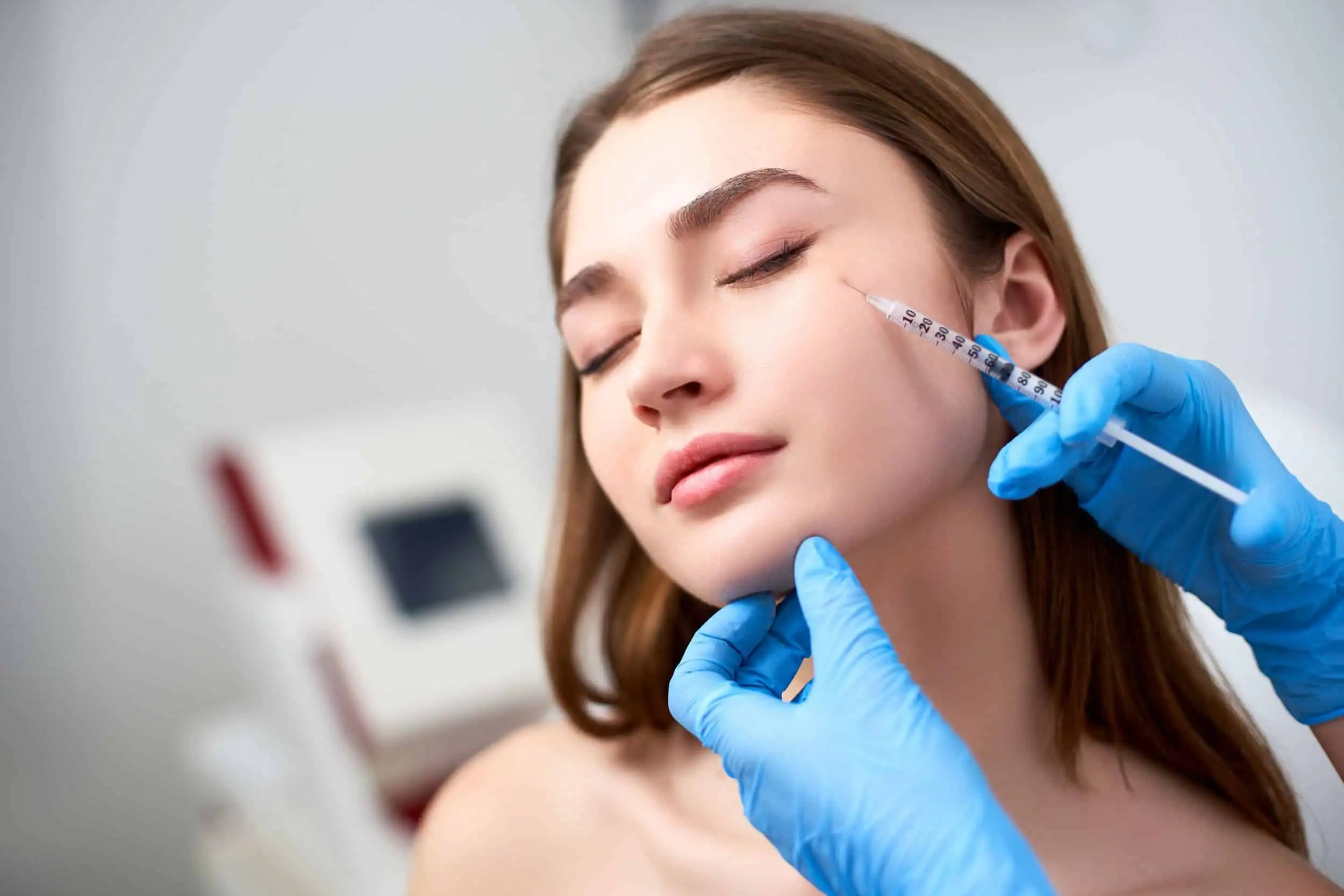 Woman receiving a cosmetic facial injection.